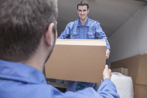 Packed moving boxes and protective materials prepared for transport