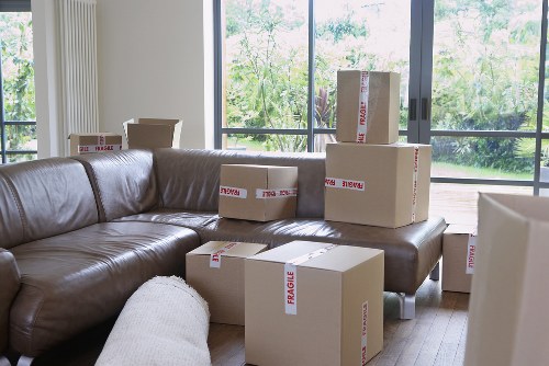 Specialist movers handling an upright piano with care